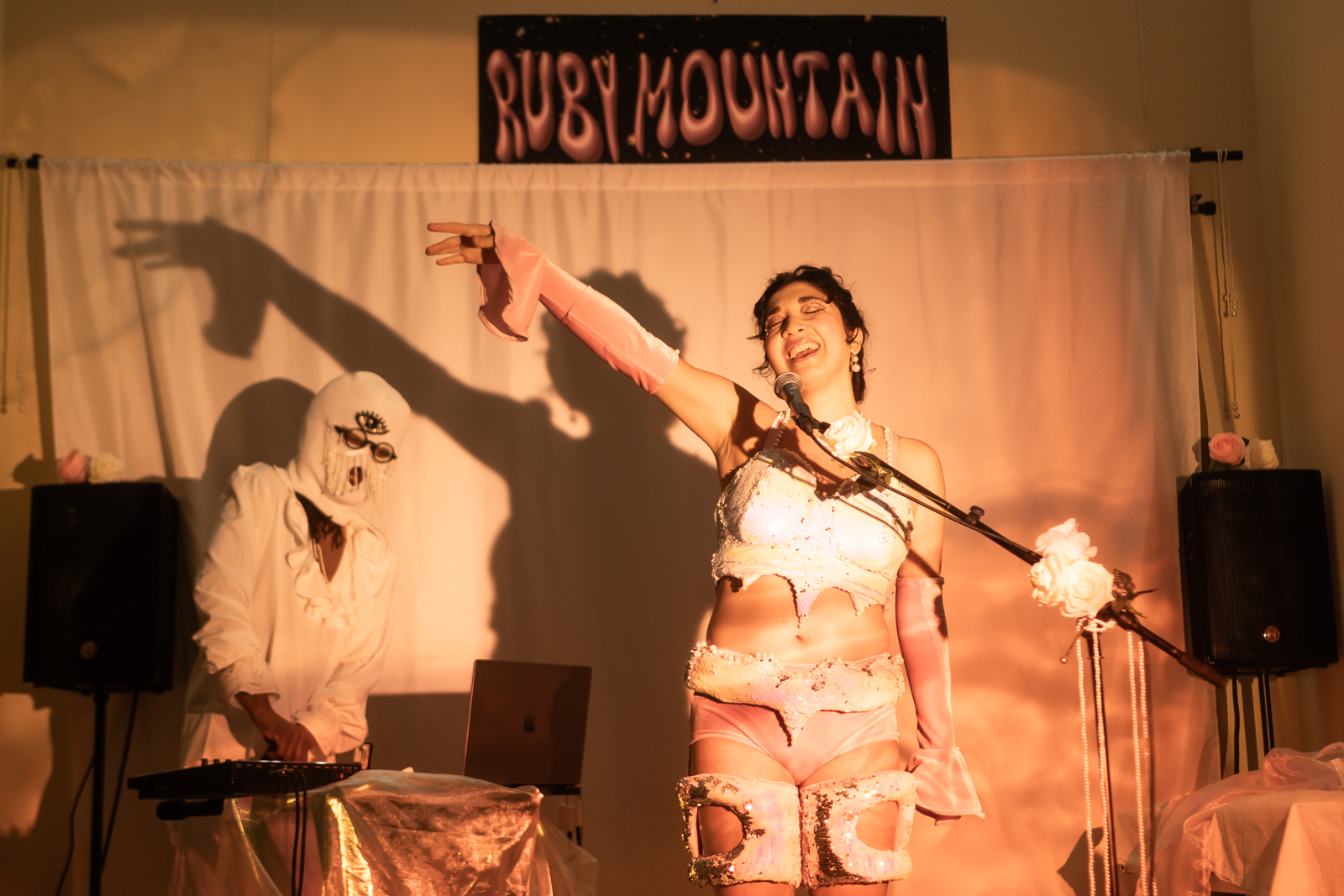 Ruby Mountain performing her single Eclipse at her 2025 listening party in Los Angeles. This photo captures her in motion, dancing to her original drum and bass track and highlighting her unique blend of live vocals and electronic music performance.