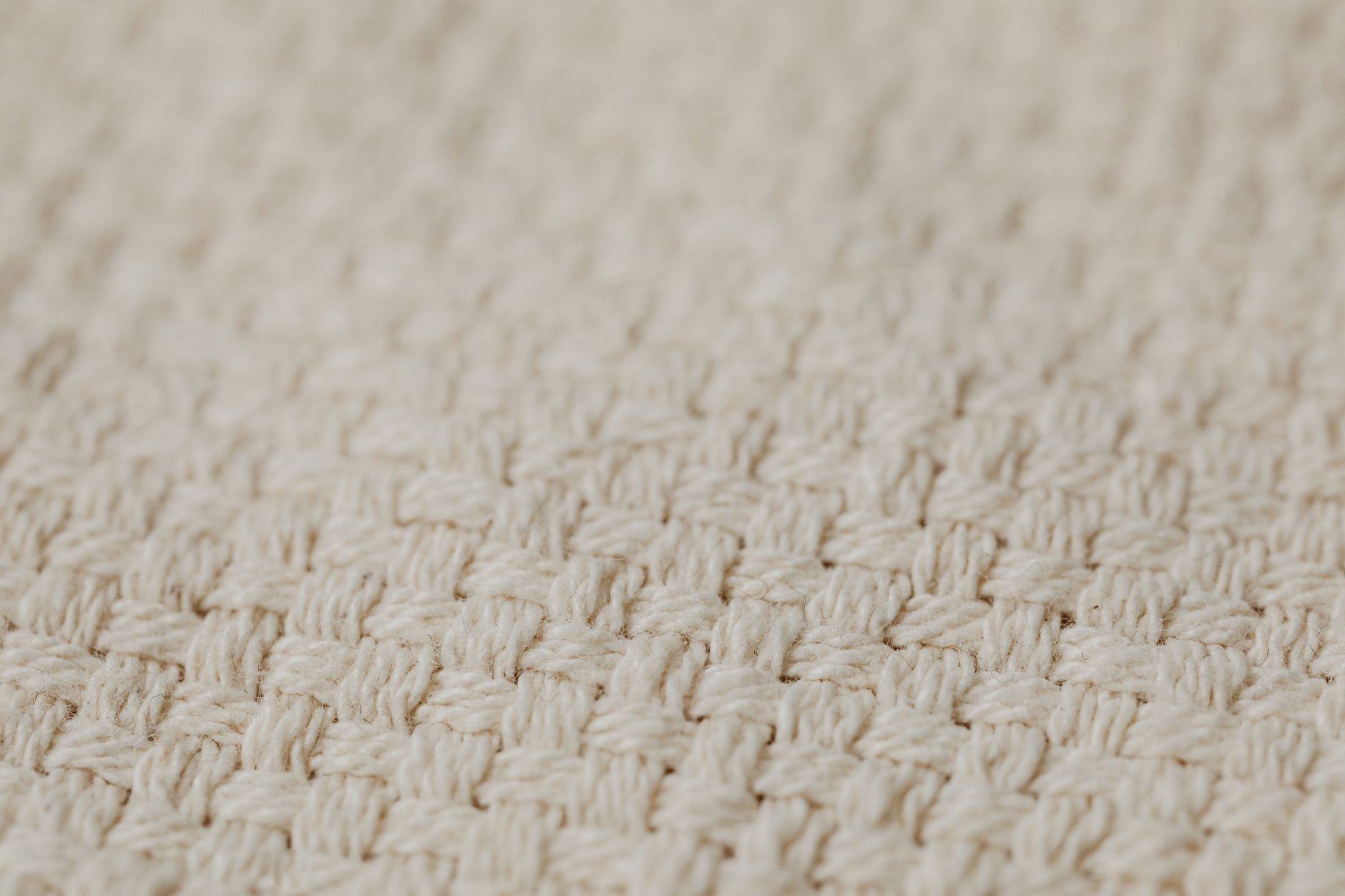 Detailed close-up image of a woven textile texture, showcasing intricate patterns.